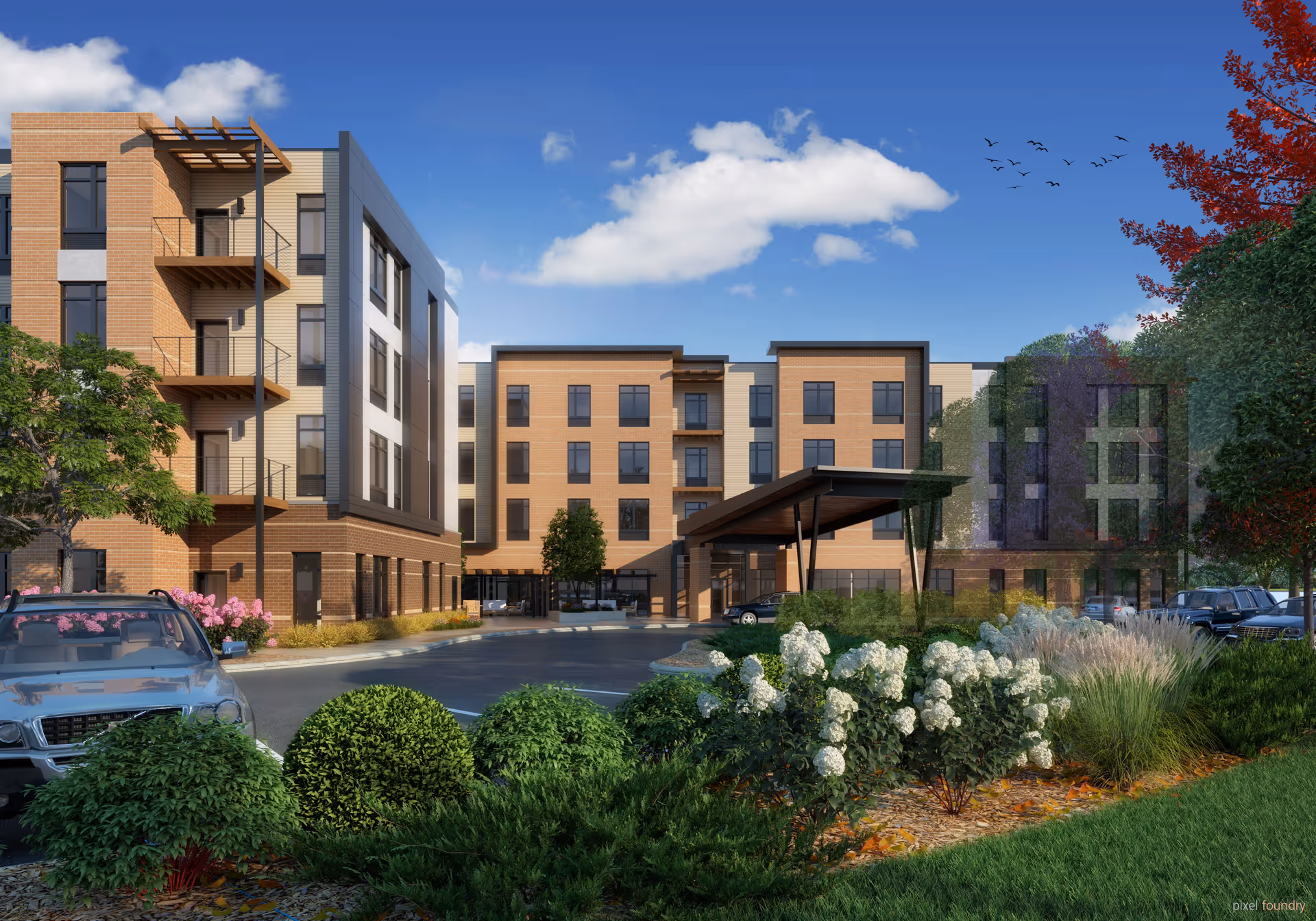 Exterior view of a modern multi-story senior living facility named The Summit of Blue Ash, featuring a covered entrance, landscaped garden with bushes and flowers, parked cars, and a clear blue sky with some clouds and birds flying.