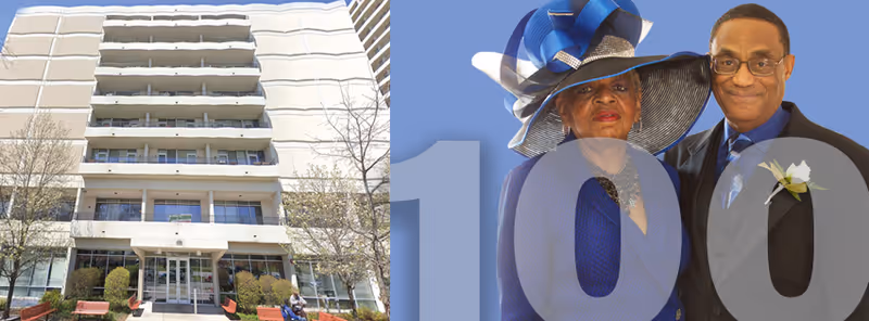 Exterior front view of a multi-story senior living facility building with balconies, trees, and benches in front. Next to the building image is a photo of an elderly couple dressed formally, the woman wearing a large blue hat and the man in a suit with a boutonniere, against a blue background with a large number 100.