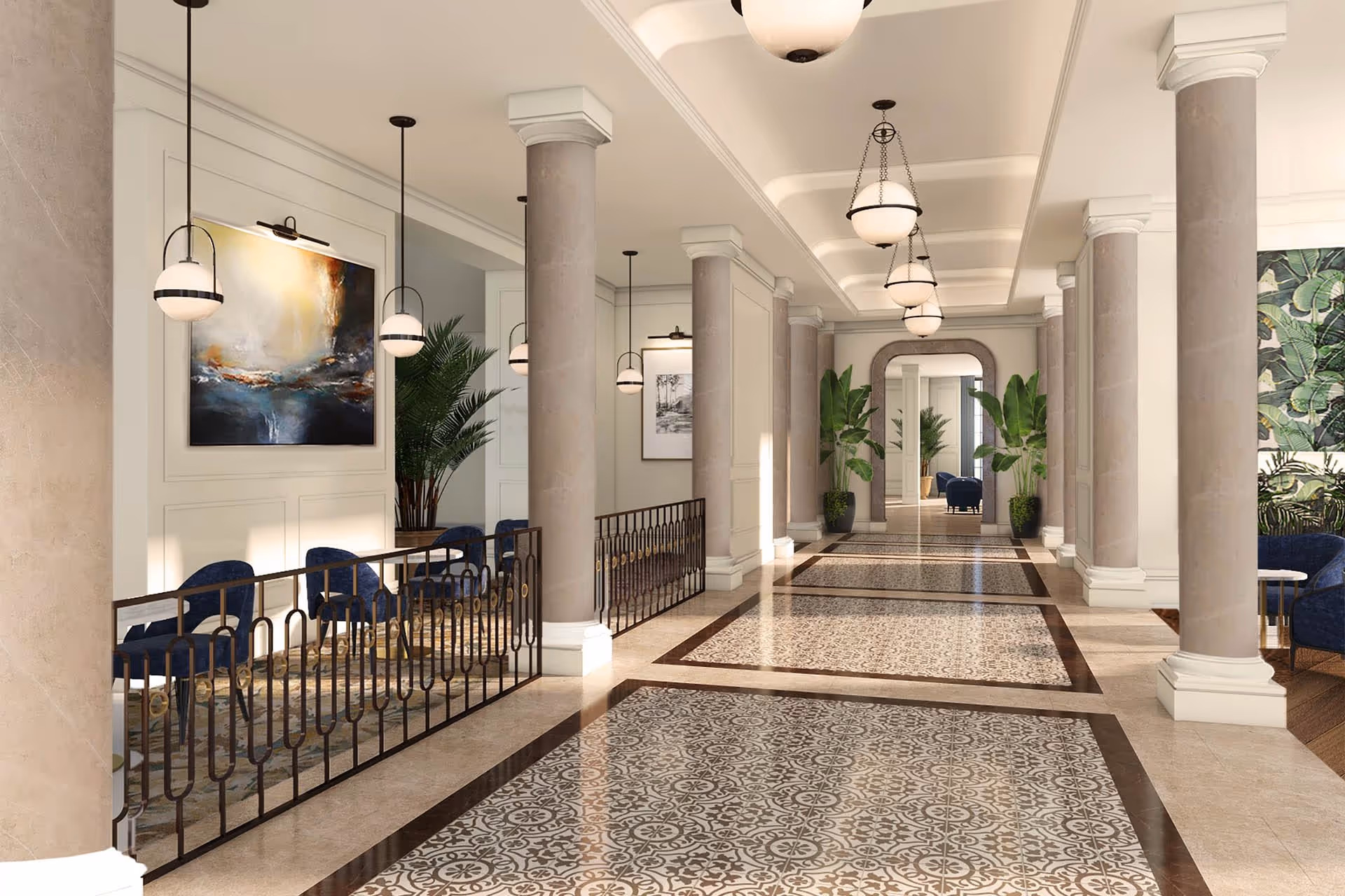 A spacious and elegant interior hallway with beige marble columns and patterned tile flooring. The hallway is decorated with hanging globe pendant lights, large potted plants, framed artwork on the walls, and blue upholstered chairs arranged in seating areas. A large mirror is visible at the end of the hallway, reflecting the space.