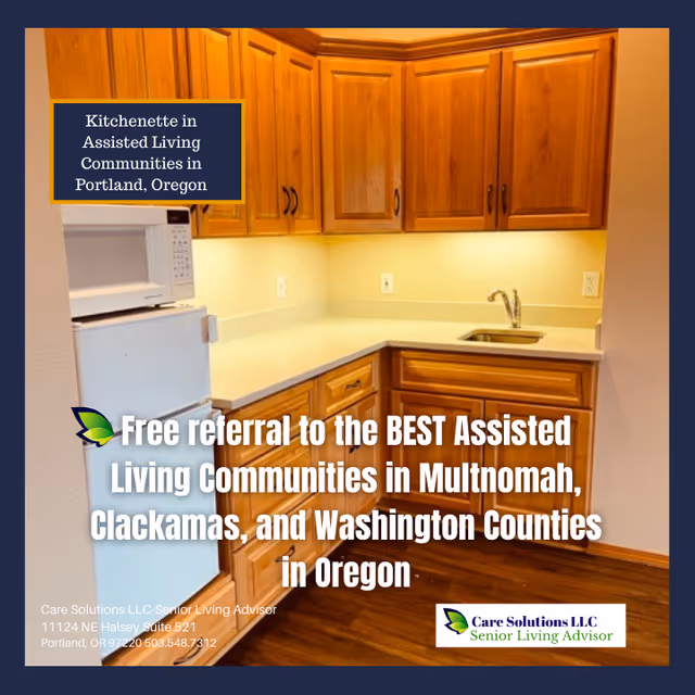 A kitchenette in an assisted living community featuring wooden cabinets, a small refrigerator, a microwave, a sink, and a countertop with under-cabinet lighting.
