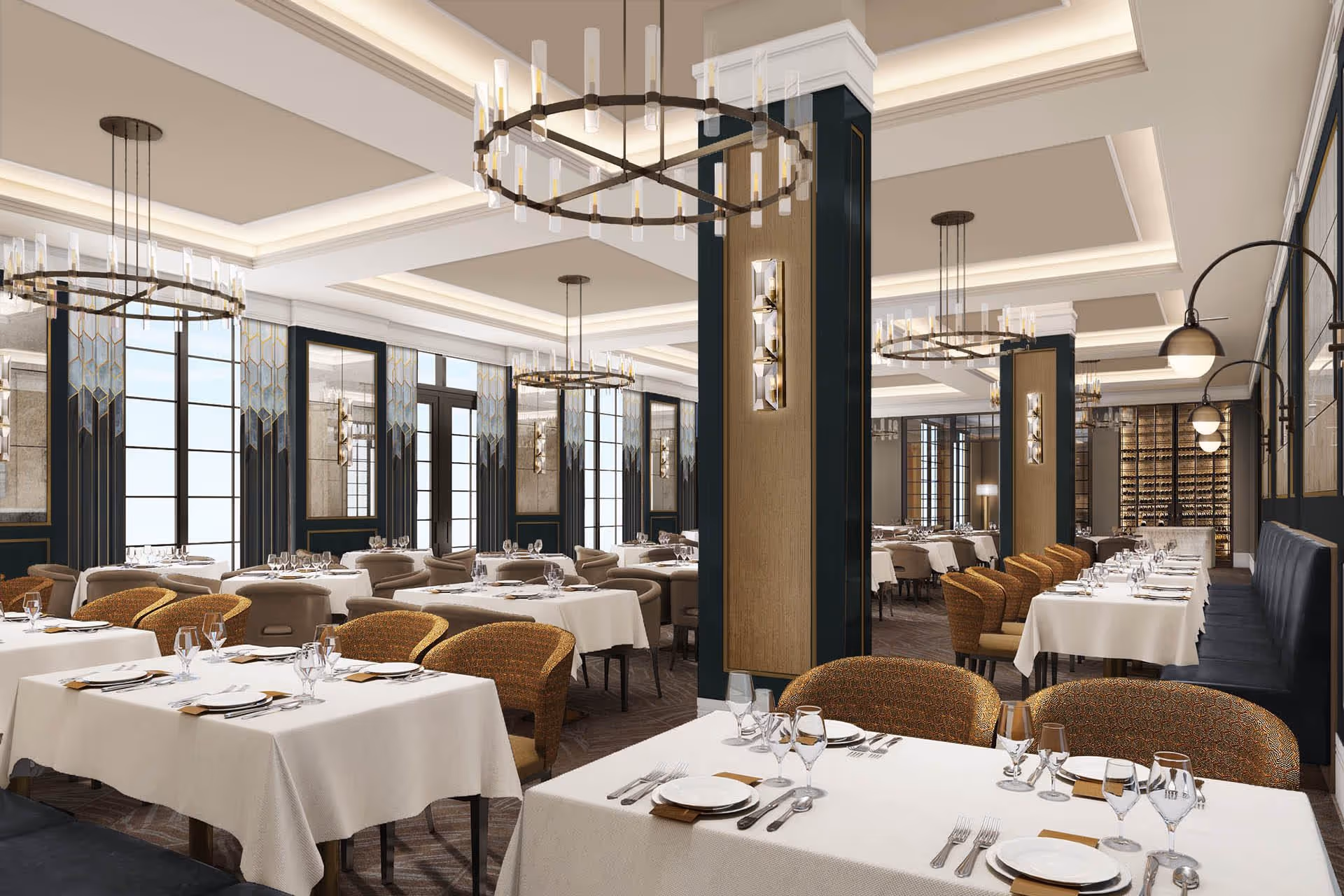 Elegant dining room with multiple tables covered in white tablecloths, set with plates, glasses, and silverware. The room features large windows, decorative wall panels, modern chandeliers, and comfortable chairs arranged around the tables.