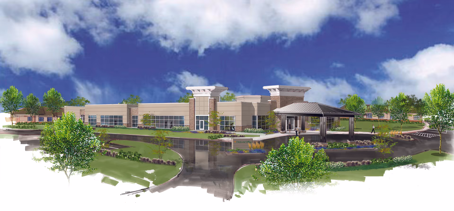 Exterior view of a modern single-story building with large windows, surrounded by landscaped greenery and trees under a partly cloudy blue sky. There is a covered entrance with a driveway and parking area visible.