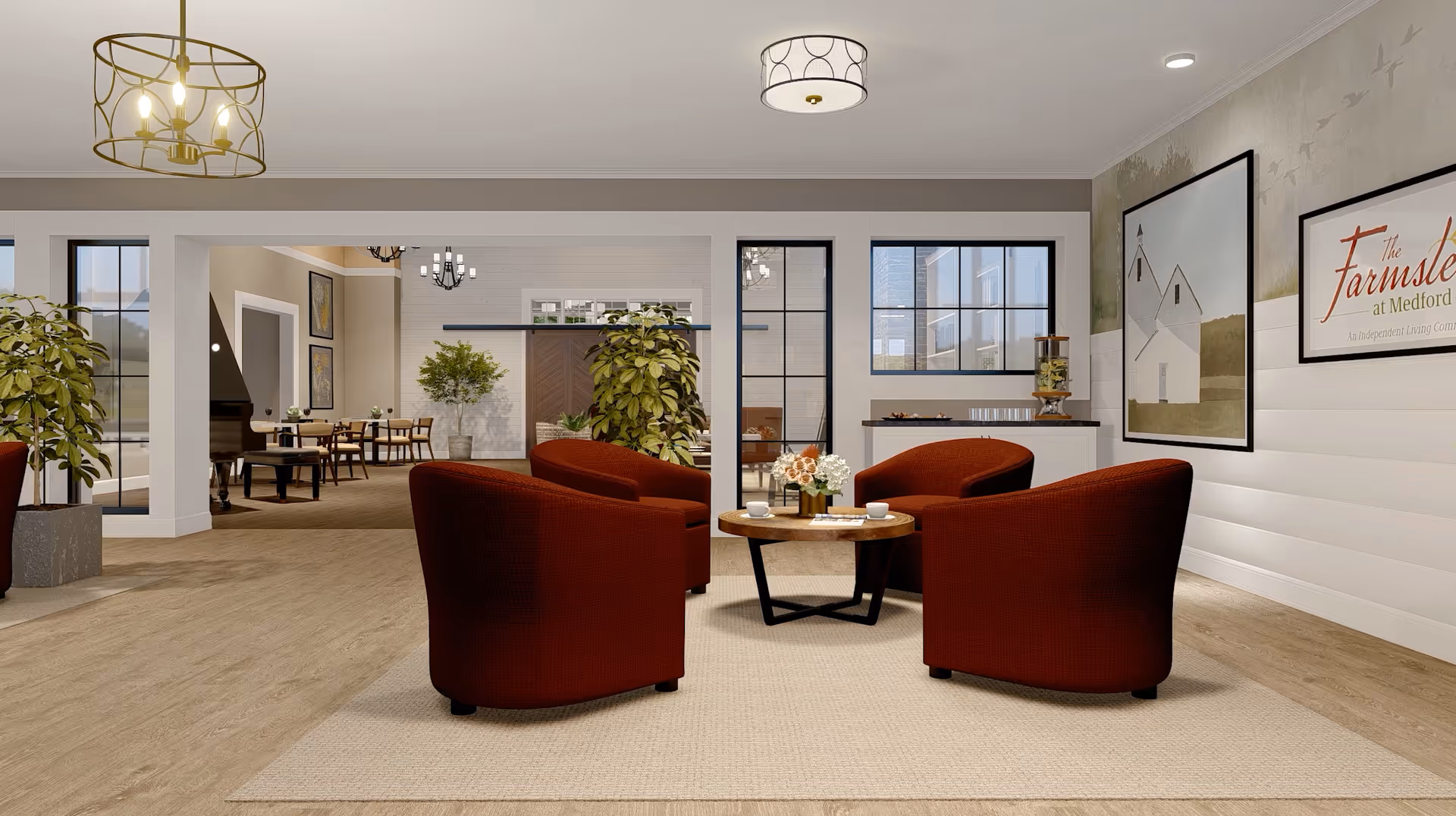 A cozy living room area with four red armchairs arranged around a round wooden coffee table on a beige rug. The room features large windows, potted plants, modern ceiling lights, and framed artwork on the walls, including a sign that reads 'The Farmstead at Medford.' In the background, there is a dining area with tables and chairs.