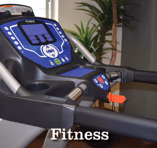 Close-up view of a treadmill control panel with a digital display and buttons, set indoors with a plant in the background.