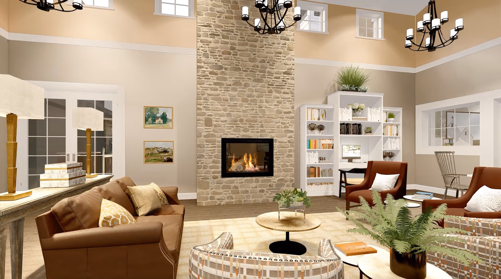 A cozy living room with a stone fireplace in the center, surrounded by a brown leather sofa, patterned armchairs, and a round coffee table with a plant. The room has high ceilings with two black chandeliers, large windows, and bookshelves filled with books and decorative items. There is also a small desk with a chair near the bookshelf and a side table with a lamp and stacked books.