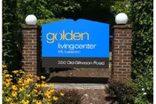 Outdoor sign for Golden Living Center Mt. Lebanon located at 350 Old Gilkeson Road, surrounded by greenery and yellow flowers.